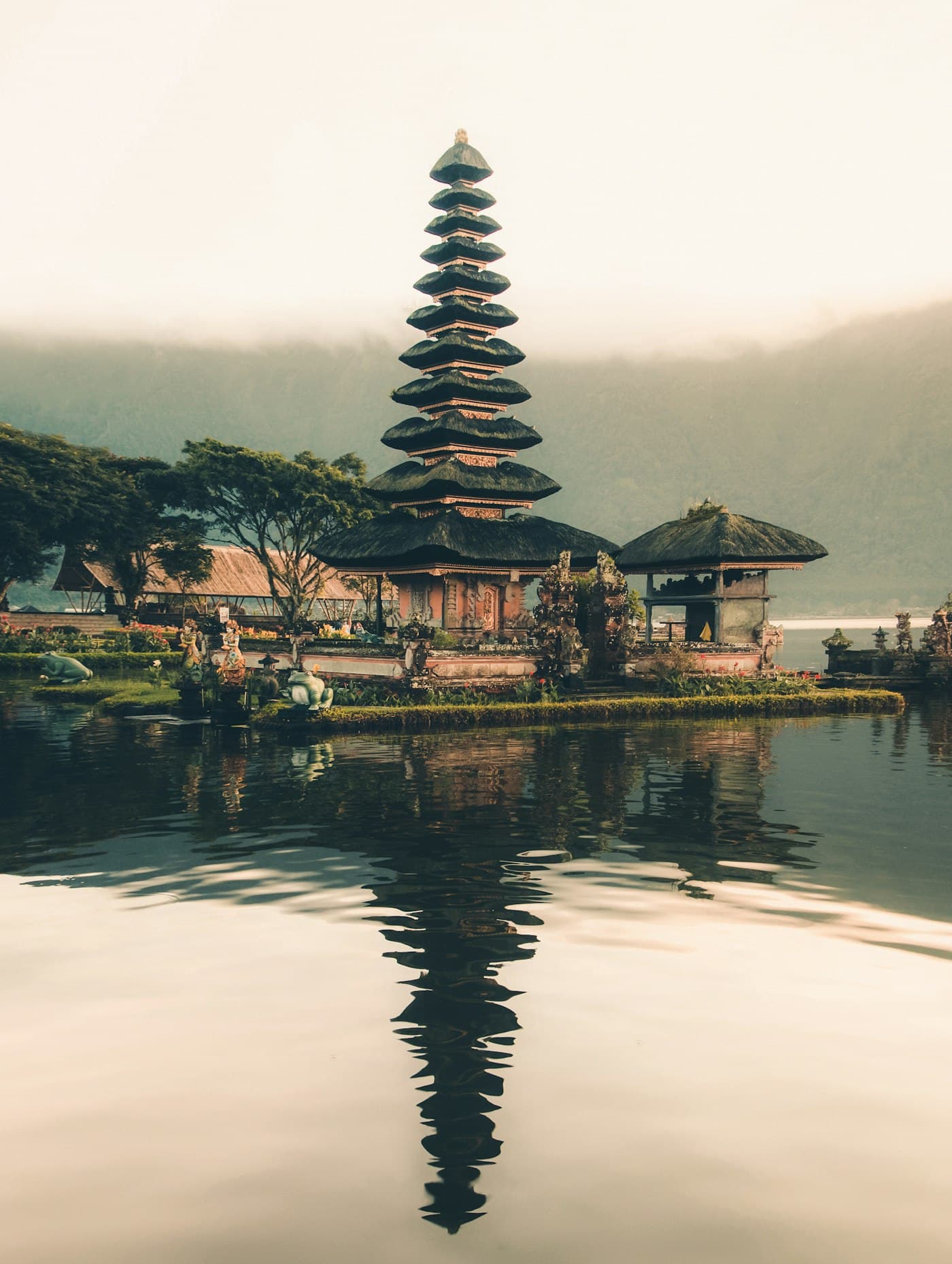 A tiered water temple reflected in a lake in Bali, Indonesia