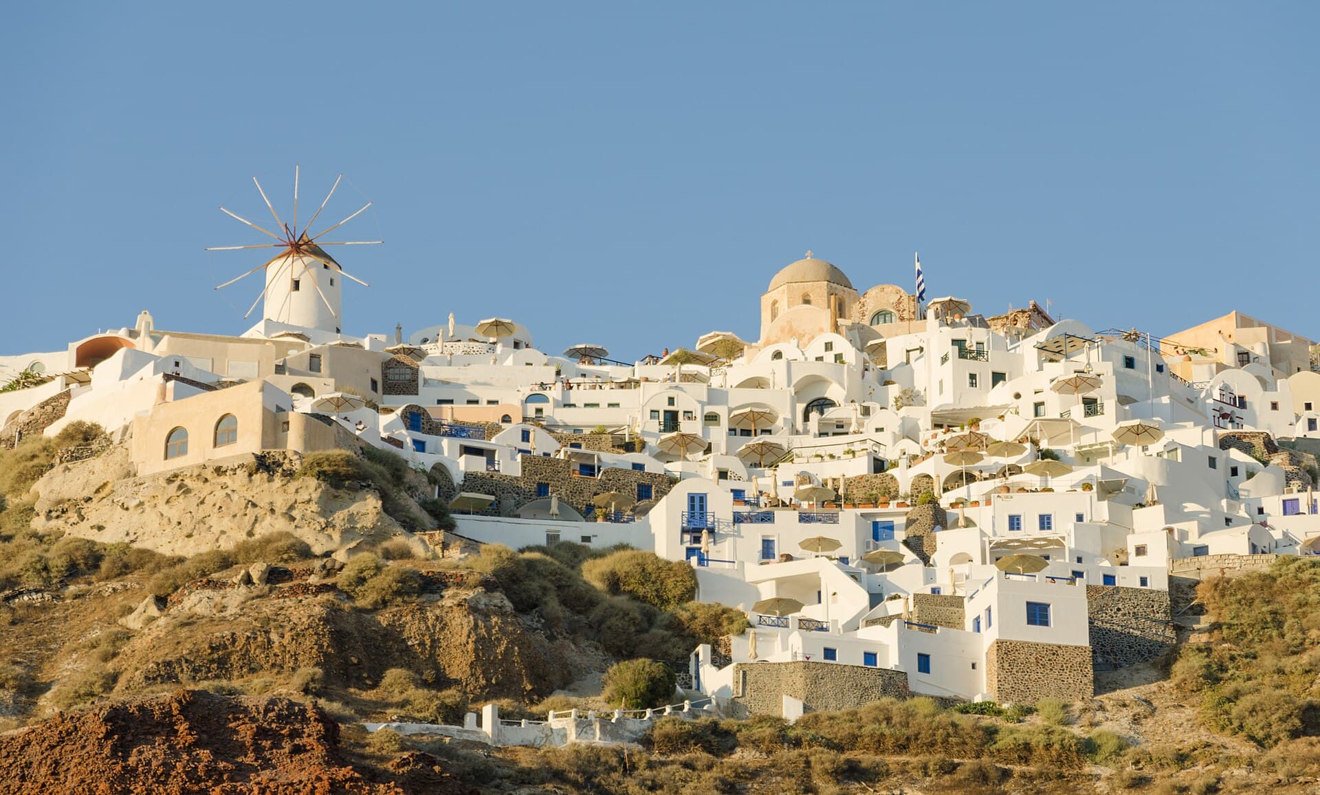 White houses and a windmill on the cliff at Oia, Santorini